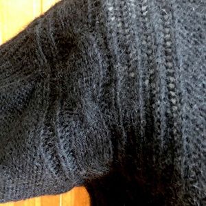 Black collarless V-neck cardigan sweater.